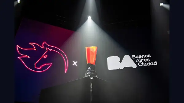 An esports trophy on a stage under a spotlight